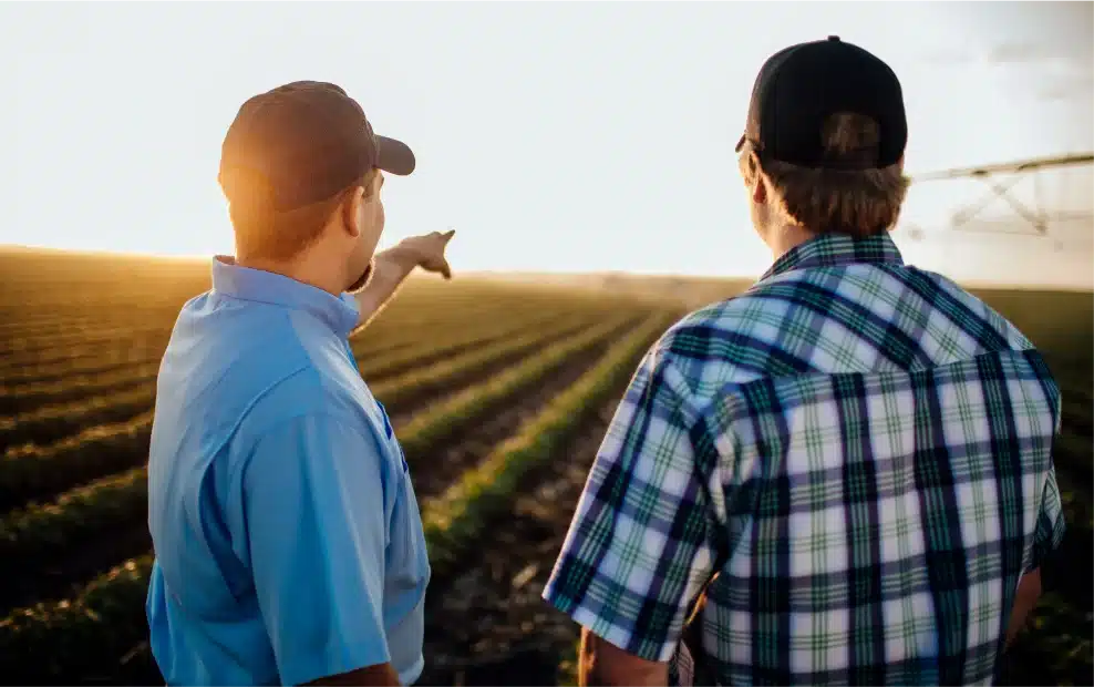 two farmers in a pivot irrigated field